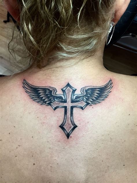 angel tattoo with cross|angel wings with a cross.